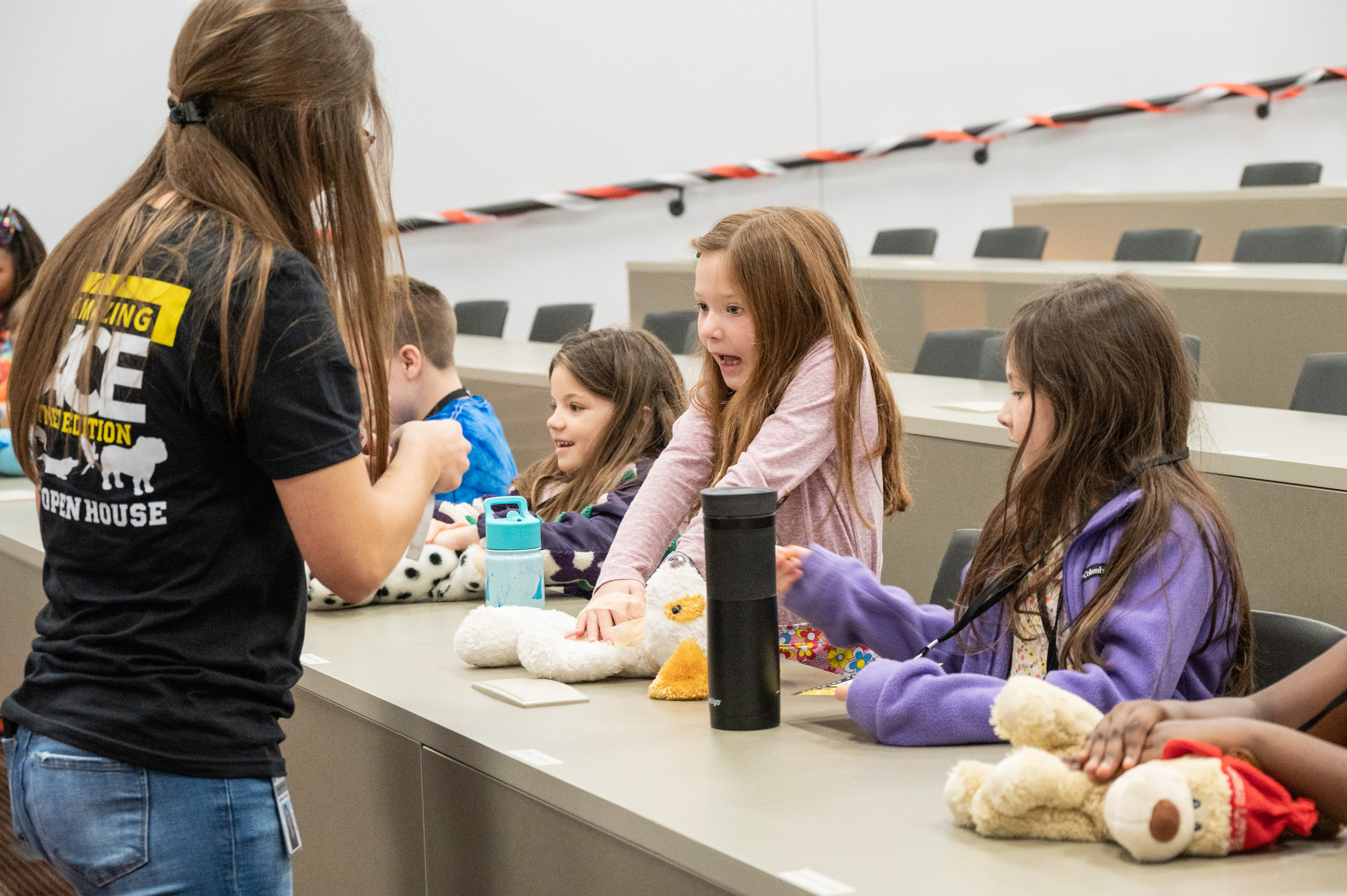 Young children learn canine CPR from a veterinary student